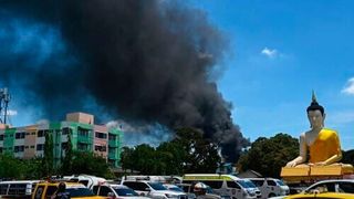 Thick black smoke billowed from the burning factory in Thailand after the fire was extinguished. (Lillian Suwanrumpha/ AFP)
