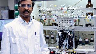 Abragam Joseph vor dem selbstgebauten Syntheseautomaten. (Bild: © Dr. Murty)