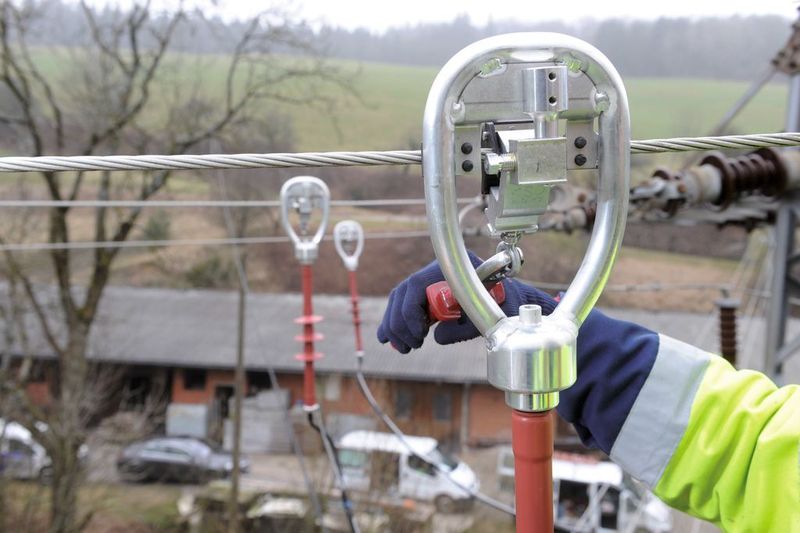 Die Montage eines optischen Stromsensors an einer Mittelspannungs-Freileitung in der kleinen Schwarzwaldgemeinde Freiamt.  (Bild: EnBW)
