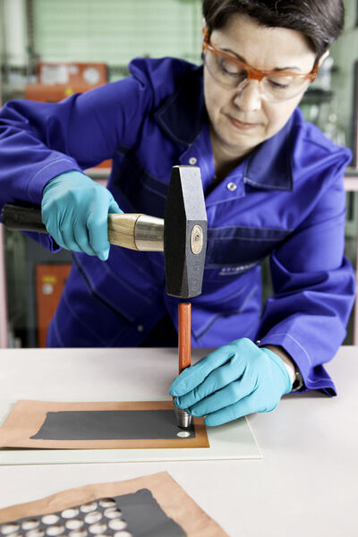 Chemical lab technician Doris Karch punches small round graphite anodes from a coated copper film. These are then inserted into the test battery. As part of the “High Energy Lithium-Ion Batteries” (HE-Lion) project, BASF is conducting research into a new generation of lithium-ion batteries (Picture: BASF)