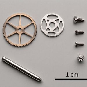 Gamme typique de pièces pour les tours automatiques à poupée mobile Hanwha : engrenages, pignons, arbres, et vis de précision de très petit format, fabriqués pour l'industrie horlogère et la technique médicale.(Source :  Osterwalder Werkzeugmaschinen AG)