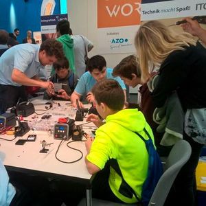Im Rahmenprogramm durften Kinder erste Erfahrungen mit der Elektronik machen. Hier wird ihnen der Umgang mit dem Lötkolben gezeigt.(Bild:  Franz Graser)