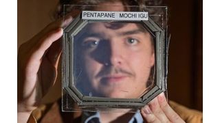 Abram Fluckiger holds up a sample panel square that has five sandwiched layers of a new material nearly transparent insulation material called Mochi, which was designed buy CU Boulder researchers in physics professor Ivan Smalyukh’s lab.
 (Source: Glenn J. Asakawa/CU Boulder)