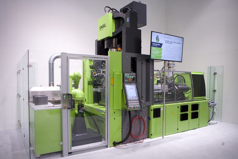 Auf einer vertikalen Engel insert US Spritzgießmaschine mit Engel easix Mehrachsindustrieroboter und Infrarot-Ofen werden endlosfaserverstärkte, thermoplastische Kunststoff-Halbzeuge erhitzt, im Werkzeug vorgeformt und unmittelbar danach mit Polyamid umspritzt. (Bild: Engel)