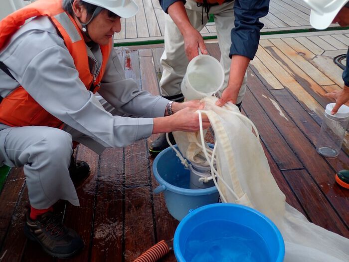 Prof Atsuhiko Isobe and gathering the microplastic samples collected from the upper ocean. (Source: Kyushu University/ Isobe Lab)
