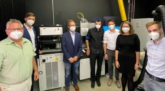 (Die Kooperationsteilnehmer Raylase und Optoprim überzeugen sich selbst an der TUM von den Vorteilen der Kombination aus patentierten Raylase AM-Modul und dem programmierbaren nLight-Faserlaser. Bildquelle: Raylase)