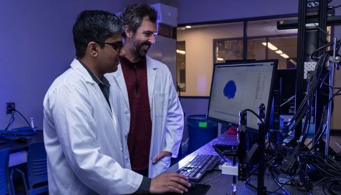 Mujtaba Rafique Ghoto (left) and Christopher O’Bryan are preparing the computer models used in the 3D printing process. (Source: University of Missouri)