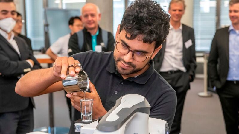 Luis Figueredo bringt einem Roboter bei, ein mit Wasser gefülltes Glas zu transportieren. 