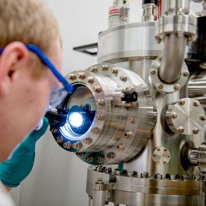 Michael Meischein vor dem Sputter-System, in dem die Nanopartikel durch simultane Beschichtung aus mehreren Quellen in einer ionischen Flüssigkeit erzeugt werden.