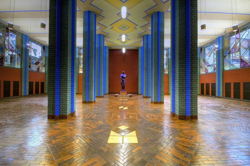 Im Inneren befinden sich der spektralfarbig gestaltete Lichthof mit drei kristallartig angelegten Glaskuppeln sowie die 2008 wieder hergestellte Ausstellungshalle. (Bild: Infraserv Höchst)