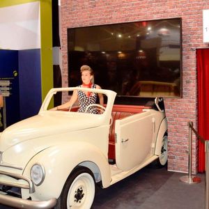 Im Kino des Messestandes läuft ein Film über die Firmengeschichte und vor stilechter Kulisse können sich Besucher mit Hostessen in Pettycoats fotografieren lassen. (Bild:  Schweitzer)