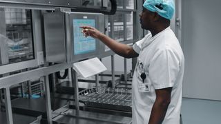 Das Krankenhauspersonal eines Krankenhauses in Kopenhagen transportiert mit dem ersten sterilen vollautomatisierten Lager für Operationsbesteck schwere Körbe mit Operationsinstrumenten per Fingertipp. (Festo)