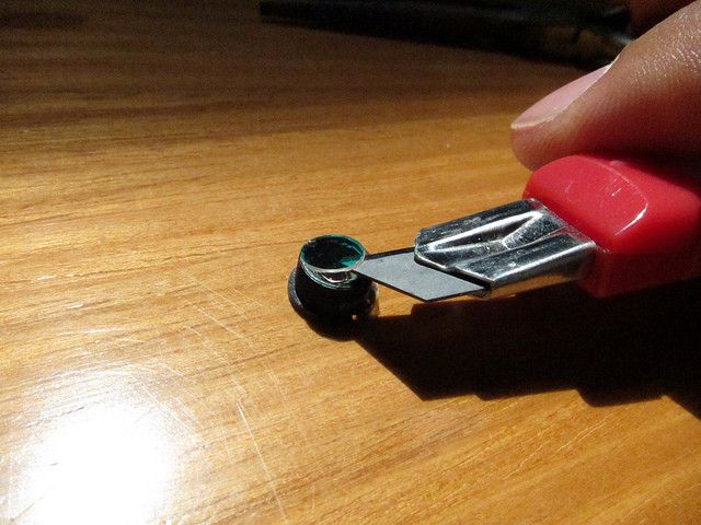 Heating the lens a bit with a hair dryer can help loosen it. The filter will look iridescent -- you can throw it away. Screw the lens back in close to how it was. (Picture: PLOTS/CC BY 2.0)