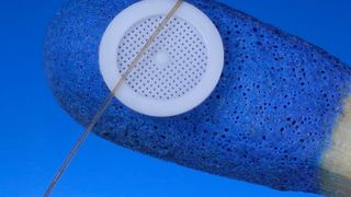 Beeindruckender Vergleich mit Haar und Streichholz aus der Mikro-Spritzgusswelt von Wittmann Battenfeld: Dieser Mikrofilter aus POM bietet ein Gitter mit 80-µm-Poren. Hergestellt auf einer Micropower 15/10 in Reinraumausführung. (Wittmann Battenfeld)