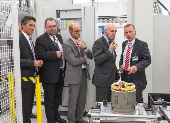 Siemens verstärkt sein Engagement für die Elektromobilität: Inside e-Car CEO Jörg Grotendorst (rechts) erläutert den Gästen, wie der Stator vorbereitet wird, um das Gehäuse zu fügen (von links): Dirk Hoke, CEO Business Unit Large Drives, Siegfried Russwurm, Mitglied des Vorstandes der Siemens AG und CEO des Industry Sektors, Ulrich Leber, Leiter der Stadtwerke Bad Neustadt und Mitglied im Förderverein Elektromobilität, sowie Landrat Thomas Habermann. (Siemens AG)