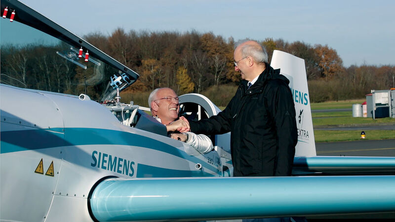 Wieder ein Eintrag in die Rekordbücher: Frank Anton (rechts), Leiter E-Aircraft in der Siemens-Start-up-Einheit Next47, gratuliert dem Piloten Walter Extra. Ihm gelang am 25. November 2016 ein Weltrekordflug im Steigflug. (Siemens)