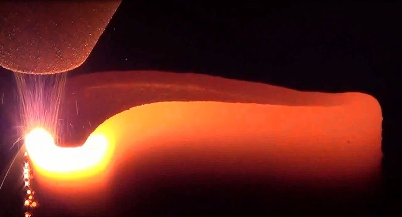 The unit’s powder jet sprays the metal  into the laser, a process said to drastically cut build time. (Source: DMG Mori)