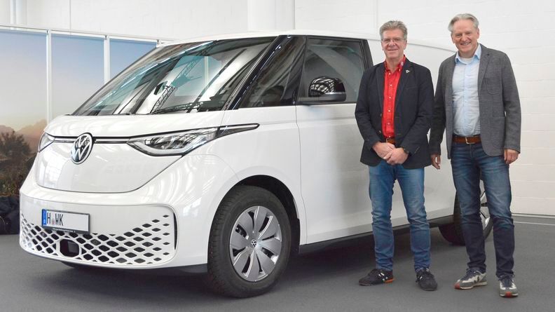 Der erste „ID.Buzz Cargo“ wurde in schlichtem Weiß ausgeliefert. Der Premierenkunde Wolfgang-Nils Kempe (links) und Thomas Schulz, Neuwagen-Verkaufsleiter bei VWN, bei der Übergabe im Kundencenter des VWN-Werks in Hannover.