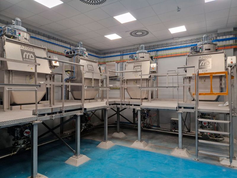 Dinnissen supplied a complete process line with bag emptying systems, rotary valves, pneumatic conveying, receiving hoppers, vibrating sieves, magnets, central dust extraction, platforms, a Big Bag filling station and a 3,000-liter Pegasus Mixer with retractable mixing shafts.  (Source: Dinnissen)