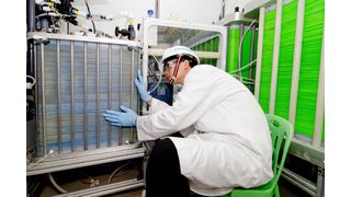 A Siemens R&D engineer examines a state-of-the-art seawater desalination prototype in Singapore.  (Picture: Siemens)