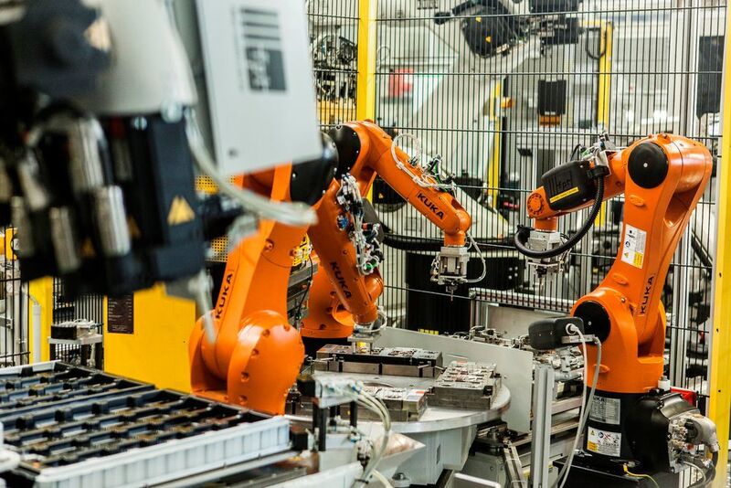At the core of the system, three KR AGILUS robots precisely place components into the injection molding machine.  (KUKA)