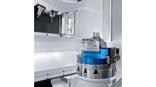 The working area of a DMP 35 fitted with the options of a 25-position tool magazine and an integrated swivelling rotary table for 5-axis machining. (DMG Mori)