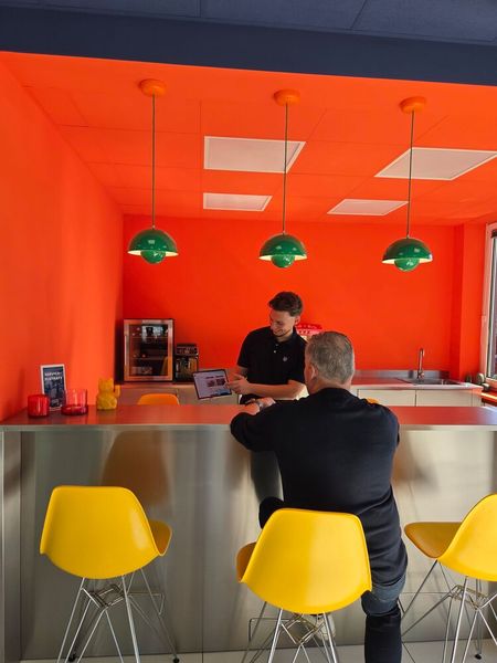 Die Bar im knalligen Orange wird auch für Verkaufsgespräche genutzt.  (Bild: Autohaus Holz)