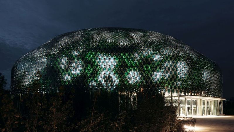 Die Fassade besteht aus mehr als 10.000 rauten- und dreieckförmige Solarmodulen und einem Gitter aus LED-Lichtern. Die Fassade besteht aus mehr als 10.000 rauten- und dreieckförmige Solarmodulen und einem Gitter aus LED-Lichtern.