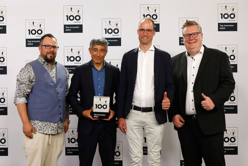 Die Othmerding Maschinenbau GmbH & Co. KG entwickelt und produziert Geräte und Maschinen für den Garten- und Landschaftsbau sowie für die Forst- und Landwirtschaft. Das Unternehmen ist Teil des Netzwerks „Deep Farm Bots“. Dies habe das Unternehmen zur neuesten Innovation inspiriert: „Roland“, ein hüfthohes Gerät, das übers Feld fährt, während Greifarme am Boden Erdbeeren ernten. Im Bild: Thomas Thal (links, Marketing Manager), Torben Othmerding (Geschäftsführer), Thomas Stohldreier (Bürgermeister).  (Bild: KD Busch/compamedia)