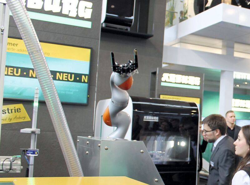 At Fakuma 2015, Arburg showed more than just the Freeformer on its own. Instead the company combined the Freeformer with its Allrounder injection molding machines as part of a cell. One highlight: A very flexible automation system showing a six-axis Kuka robot loading and unloading a Freeformer. (Schulz)