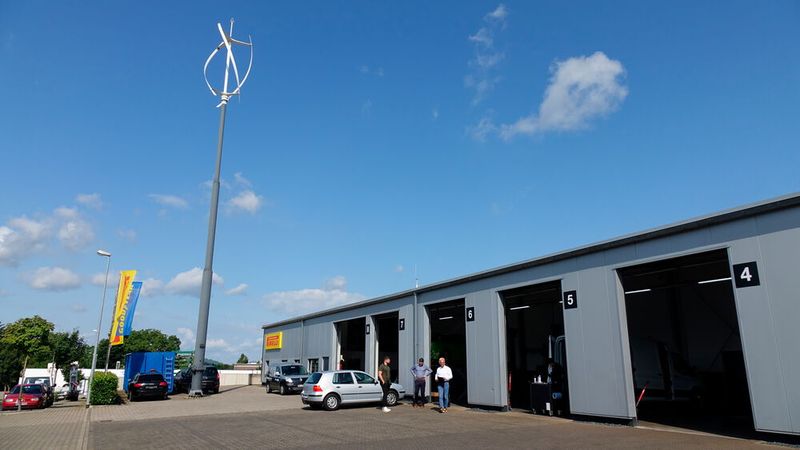 Einen Kfz-Betrieb – egal ob Vertragspartner oder markenunabhängig – mit einem eigenen Windrand haben auch wir noch nicht gesehen, bis wir bei Reifen Schuster in Rommerskirchen waren. Inhaber und Geschäftsführer Christoph Schuster hat bereits viel in die Effizienz seines Betriebs investiert. Neben eben jenem besagten Windrad gehört eine PV-Anlage auf dem Dach sowie ein BHKW im Keller zum Konzept des Reifenbetriebs. (Bild: Schreiner – VCG)