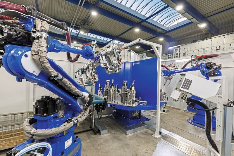 Blick in die Zelle: rechts der Punktschweißroboter, im Vordergrund die Lasersignierstation und links der GP88 Sechsachser für die Handhabung. (Bild: Yaskawa Europe)