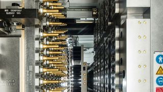 Alle 5 Sekunden liefert ein Werkzeug von MHT 92 reagenzglsartige PET-Peforms für die Flaschenproduktion im darauf folgenden Blasformprozess. Beschichtungs-Know-how von Oerlikon Balzers Coatings sorgt, wie hier auf den Kernen als golden glänzende Applikation zu erkennen, dafür, dass die Rasanz beim Spritzgießen stets gewährleistet ist. (Oerlikon Balzers)