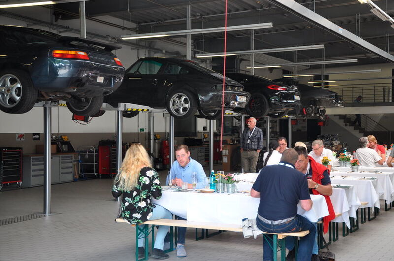 Mittagessen unter schwebenden Porsche-Fahrzeugen! In der großen Servicehalle des Porsche-Zentrums Würzburg gab es kulinarische Stärkung. (Weissenberger / »kfz-betrieb«)