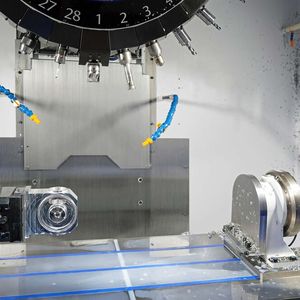 The machine was supplied in a variant with the column raised by 300 mm to accommodate a 4th axis and trunnion arrangement. Here the trunnion has been removed for machining a component mounted directly in the indexing head. (Source:  Whitehouse Machine Tools)