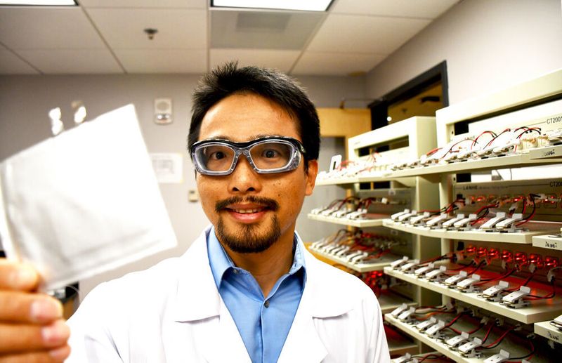 Associate Professor Feng Lin of the Virginia Tech Department of Chemistry holds a pouch battery cell in his battery-testing lab at Davidson Hall. Photo for Virginia Tech by Steven Mackay. (Virginia Tech)