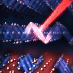 Die Darstellung zeigt, wie ein Laser-Impuls (rot) die nicht-leitende Struktur (blau) im Magnetit stört und so einen leitenden Bereich schafft