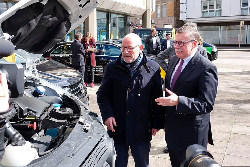 Dieter Roßkopf (Vorstandsvorsitzender des ADAC Württemberg, rechts) erläuterte Winfried Hermann ein nachgerüstetes Dieselfahrzeug. (»kfz-betrieb«/Jan Rosenow)