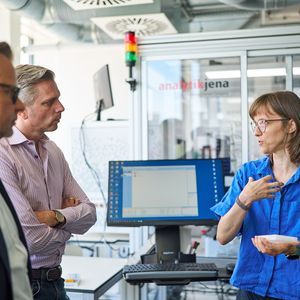 Zusammenspiel von Forschung und Mittelstand: Nachwuchsgruppenleiterin Luzia Gyr und Lars Böttcher von Analytik Jena erläutern Sascha van Beek (mitte links) die Zusammenarbeit rund um die Robotik-Plattform Jen-Xplore.(Bild:  Anna Schroll/Leibniz-HKI)