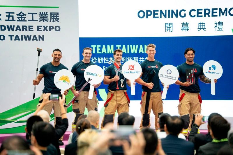 Representatives from the Australian Firefighters Calendar take the stage at the opening ceremony holding Taiwan-made professional tools, highlighting the exceptional reliability and disaster-resilience applications of Taiwanese hardware from a frontline user perspective. Showcased on stage from right to left are: A-Kraft's KH3300 Air Ratchet Handle, Easen Hardware's Special Open-End Wrench, Jun Kaung's Lightweight Hand Puller, Stand Tools' Industrial Digital Torque Wrench, and Sunny Box's Adjustable Weeding Knife. (Source: Lanza International )