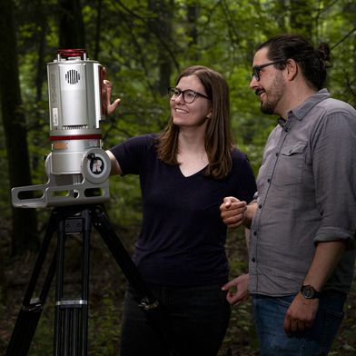 Dr. Katja Kowalski und Prof. Cornelius Senf bei der Arbeit mit einem Laserscanner. Der Scanner ermöglicht es, ein digitales, 3-dimensionales Abbild eines Waldes anzufertigen. (Bild: Sebastian Kissel / TUM)