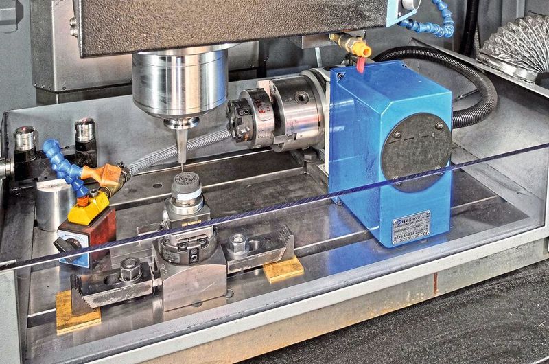 An enclosure mounted on the table has air extraction to remove graphite dust. (Hurco)