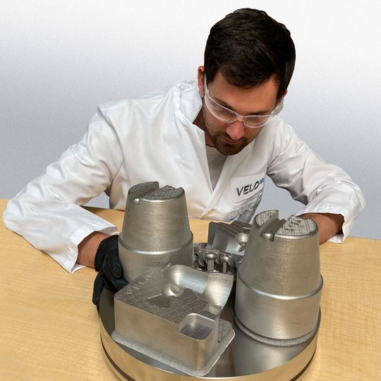 Engineer evaluating an M300 tool steel print of conformal cooled tooling and high pressure die casting inserts. These types of inserts are widely used to manufacture parts for the automotive industry.(Source:  Business Wire)