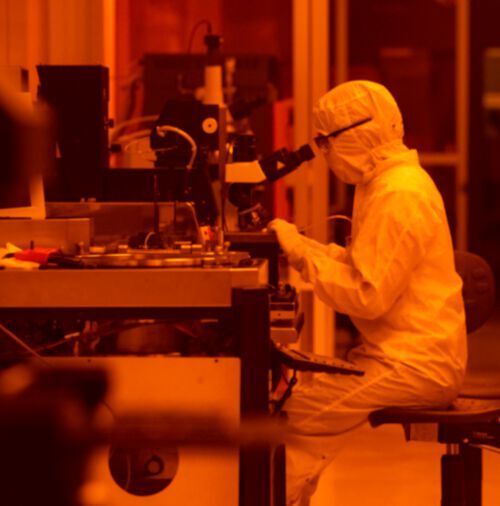 Frances Camille Wu, a graduate research assistant in the Microelectronics Research Center, uses a microscope to study electronic devices in a clean room at the Pickle Research Campus in Austin, Texas.