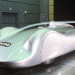 Zu Anfang des Jahres 1937 beginnt die Auto-Union-Rennabteilung mit der Entwicklung eines Vollstromlinienwagens auf Basis des Auto Union Typ C. Motor und Chassis bleiben nahezu unverändert. Die Gestaltung der Stromlinienkarosserie basiert größtenteils auf der Arbeit von Josef Mickl, dem Aerodynamiker im Konstruktionsbüro Porsche. Die Stromlinienkarosserie feiert beim AVUS-Rennen 1937 Premiere. Noch im gleichen Jahr fährt Bernd Rosemeyer mit diesem Rennwagen auf der Autobahn Frankfurt – Darmstadt zum ersten Mal eine Geschwindigkeit von über 400 km/h auf normaler Straße und stellt mehrere Geschwindigkeitsweltrekorde auf.(Bild:  Audi AG)