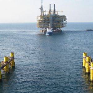 ... an oil rig is transported to its prepared legs on the seabed of the Arabian Gulf...