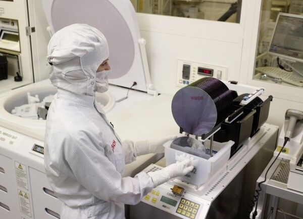 Automotive Electronics: In der neuen Halbleiterfertigung von Bosch entstehen integrierte Schaltkreise (IC) und mikromechanische Bauelemente (MEMS). Ausgangsmaterial sind dünne Siliziumscheiben, so genannte Wafer, mit einem Durchmesser von 200 Millimetern. Im Bild: Eine Mitarbeiterin belädt eine Reinigungsanlage für Siliziumwafer. (Bild: Bosch)