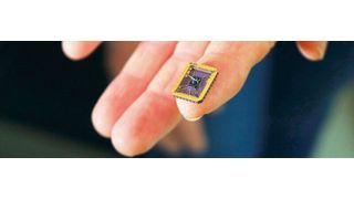 Claire Berger, a physics professor at Georgia Tech, holds the graphene component grown on a silicon carbide substrate chip created by the team. (Picture: Jess Hunt-Ralston, Georgia TechJess Hunt-Ralston, Georgia Tech)