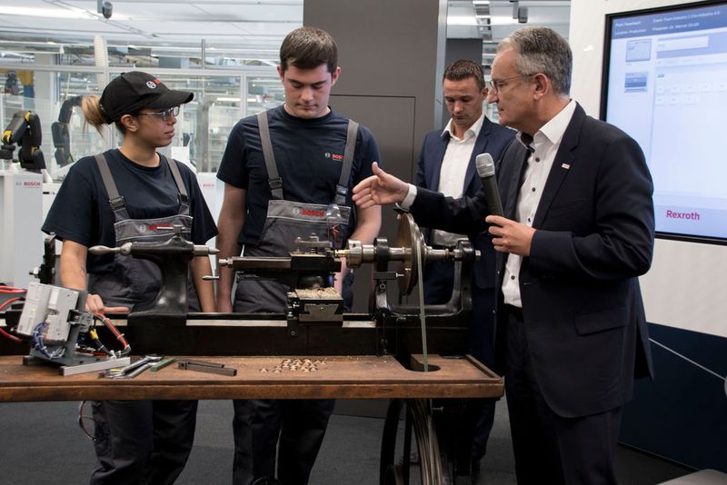 Auch nach über hundert Jahren läuft die Drehbank noch: Die beiden Azubis Sina Rohloff und Felix Meeh zeigten die Maschine in Aktion. (K.Juschkat/konstruktionspraxis)