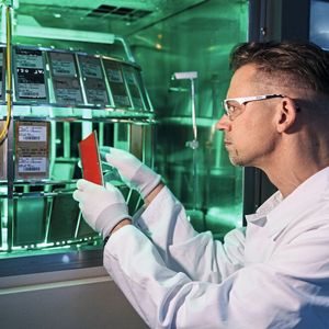 Bei der Anwendung im Luftverkehr sind Außenflächen unter anderem starken UV-Strahlungen sowie Temperatur- und Druckschwankungen in großen Höhen ausgesetzt. BASF-Mitarbeiter Dirk Schmelter prüft mittels einer künstlichen Sonne die Auswirkung von UV-Strahlungen auf den Riblet-Film.(Bild:  BASF)